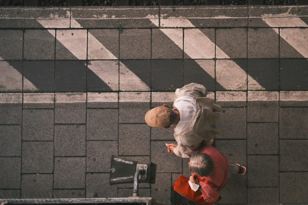 a person walking down a street next to a bike