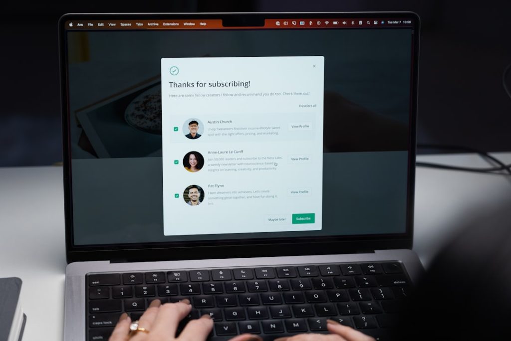 a woman is typing on a laptop keyboard