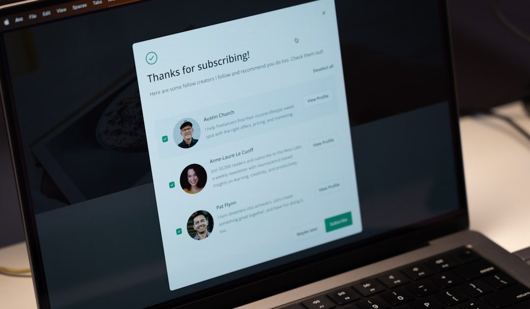 Laptop screen displaying subscription confirmation with creator recommendations