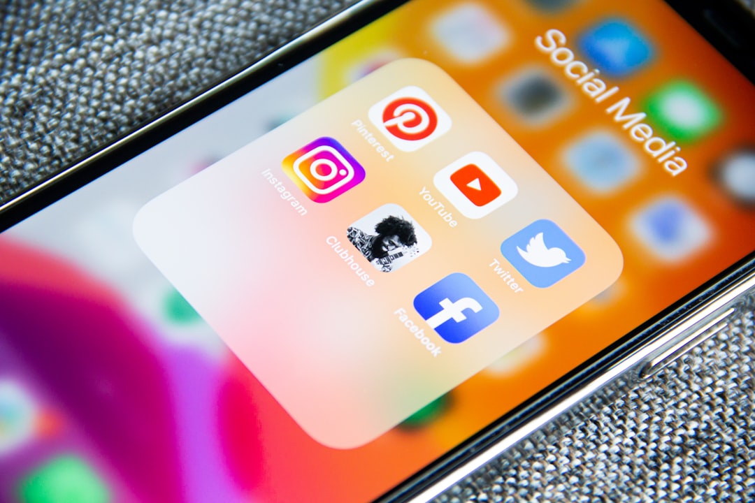Social media app icons on a smartphone screen with a textured grey background