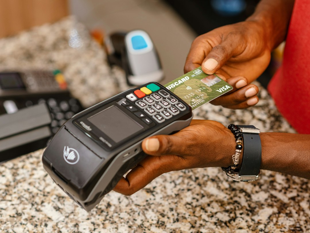 a person holding a credit card in their hand